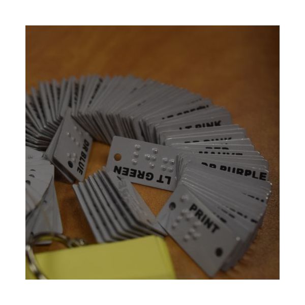 white, aluminum labels marked in Braille and print